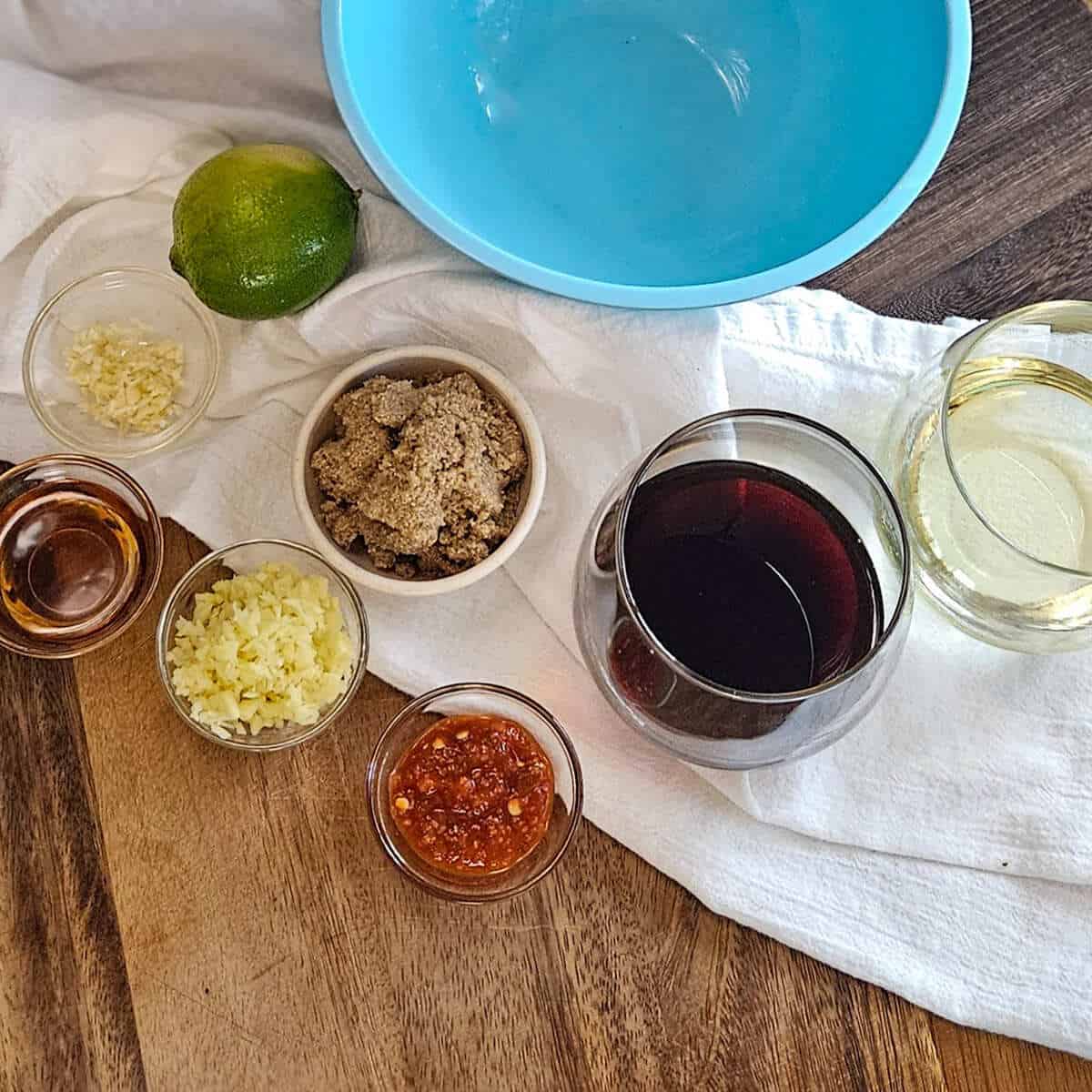 The ingredients for the dressing for the easy Asian broccoli crunch salad with a bowl to mix them in.